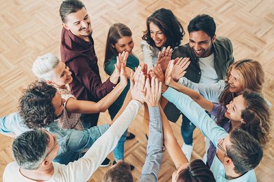 A group of people high-fiving each other