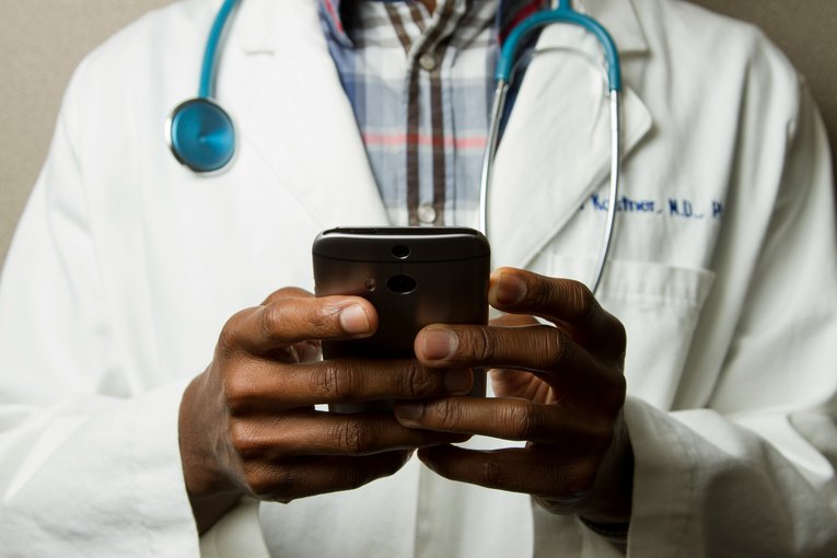 Doctor looking at cell phone